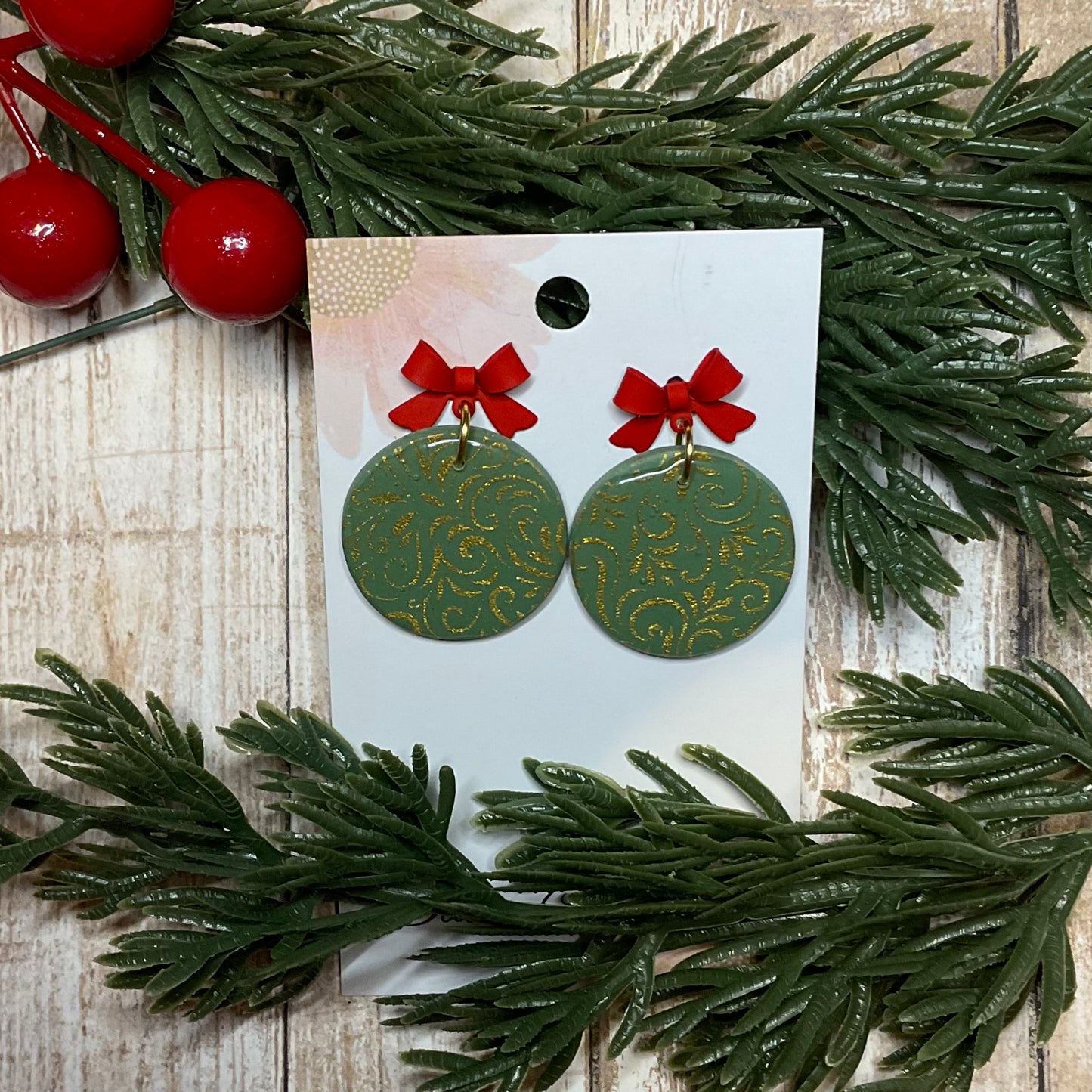 Silkscreened bauble dangle earrings with red bow stud