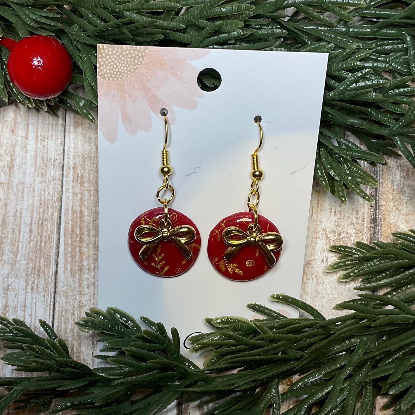Silkscreened bauble dangle earrings with golden bow charm
